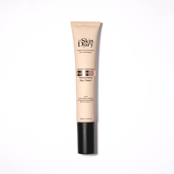 A tube of The Skin Diary Moisturising Day Cream on a clean white background. The tube is beige with a black cap, and the brand name 'The Skin Diary' is printed in black on the front.