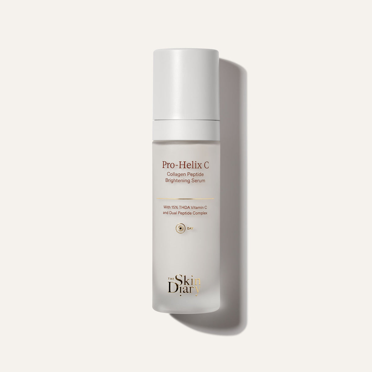 A frosted glass skincare bottle reading 'Pro-Helix C Collagen Peptide Brightening Serum' and 'The Skin Diary', set against a warm off-white background with a soft shadow.