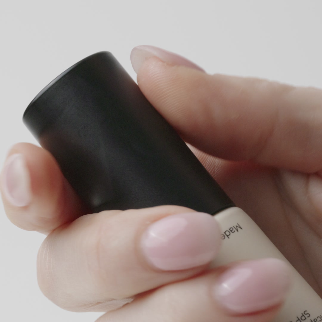 Macro video of Age Defence showing a womans hand open the cap, and pump out the velvety cream.